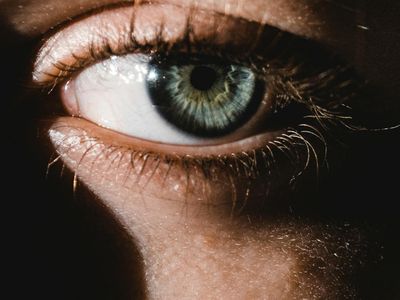 Close-up of a person's calm face with eyes closed, deep in concentration.